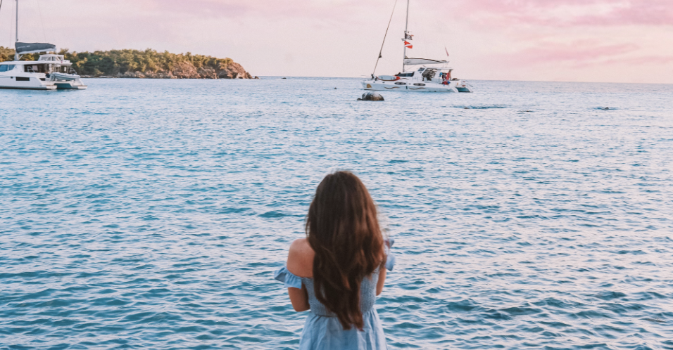 Girl watching ocean sunset